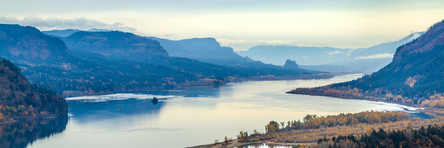 A scenic view of the Columbia River Gorge and the Cascade Mountains in the fall