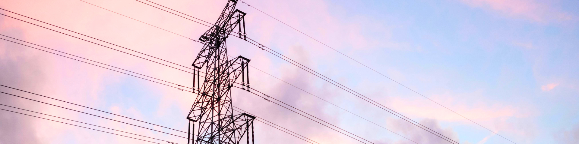 transmission lines against a cotton candy-colored sunset
