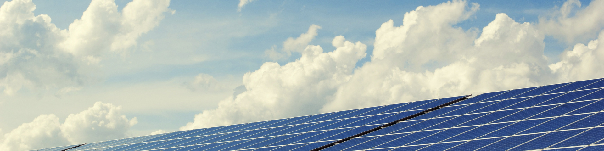 Solar panels against a cloudy sky
